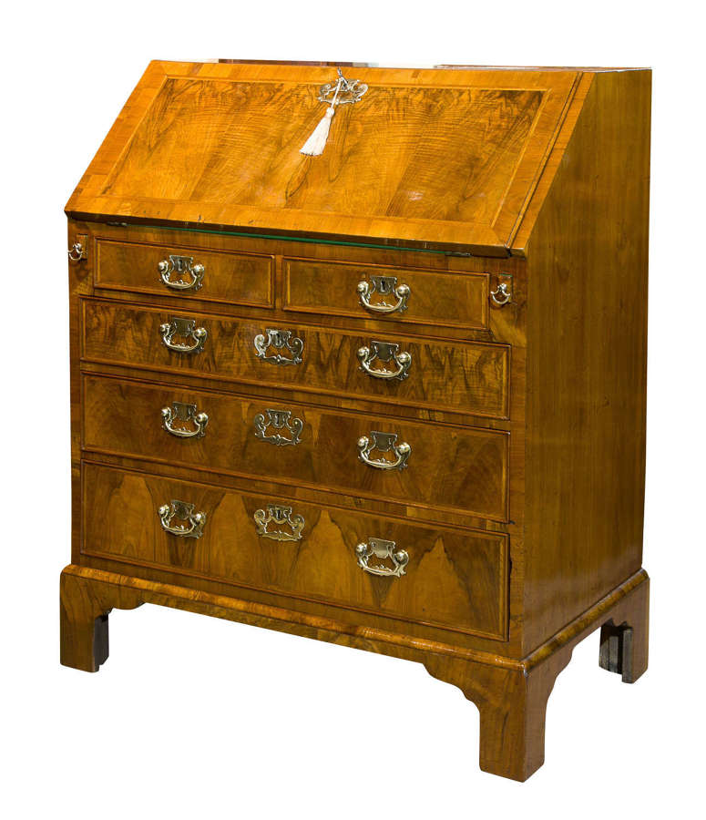 A Queen Anne walnut and feather banded bureau