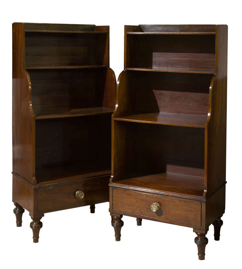 A pair of mahogany George III style waterfall bookcases