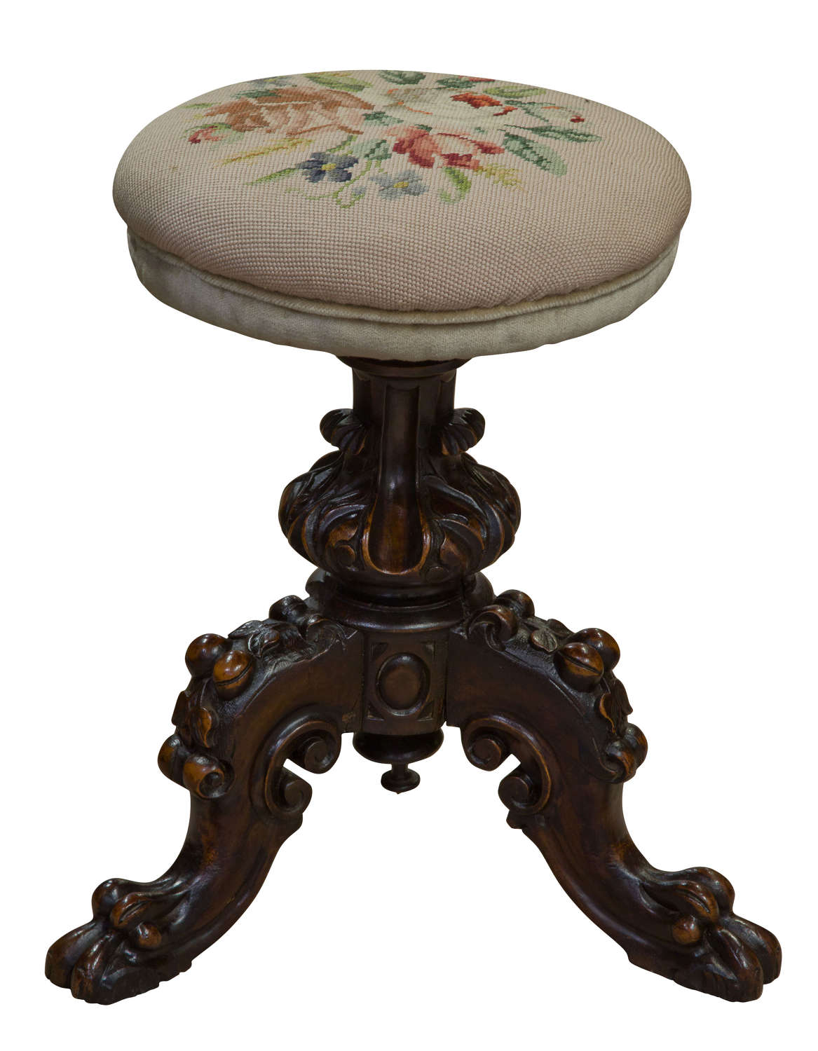 A mid Victorian carved walnut circular adjustable piano stool