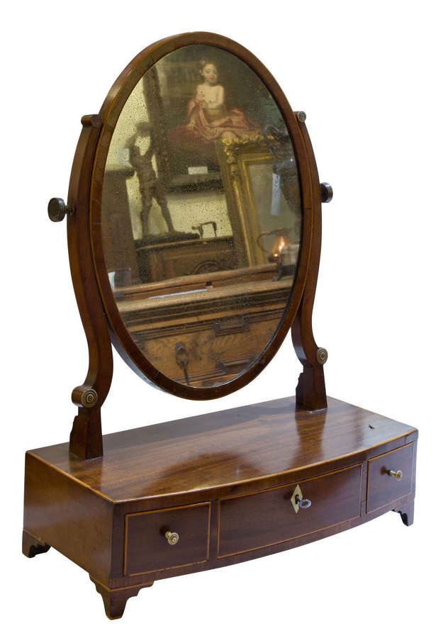 An Early 19thCentury mahogany oval dressing table mirror