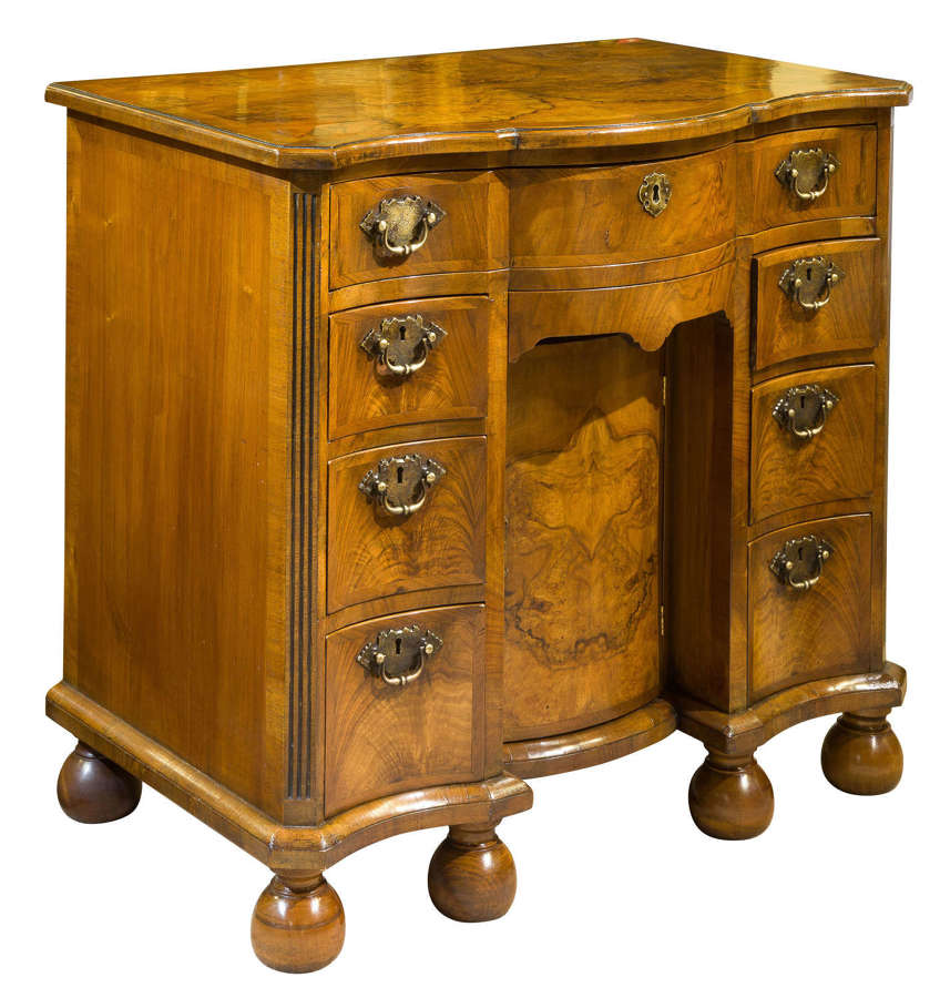 A Burr and Figured Walnut Serpentine Fronted Kneehole Desk